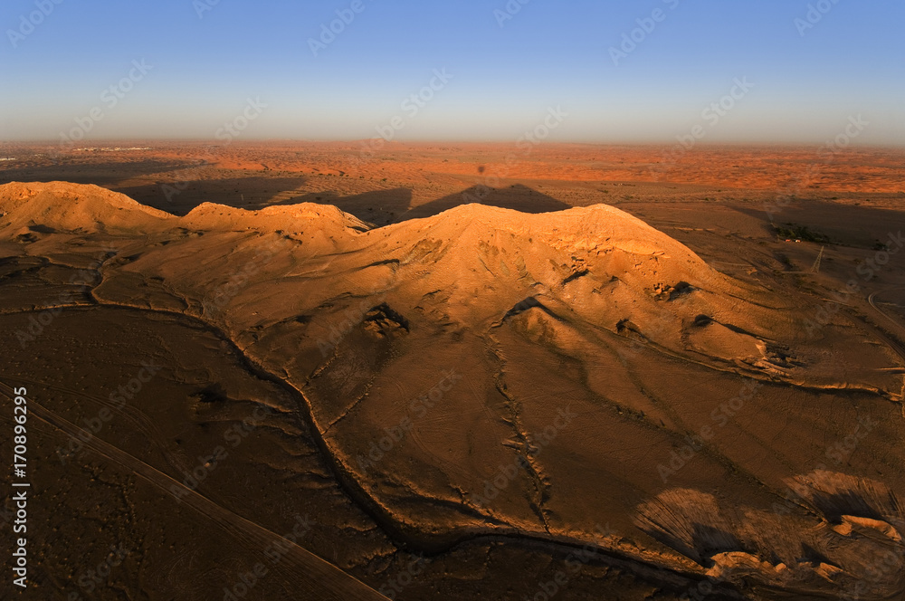hot air balloon flight over desert mountain range