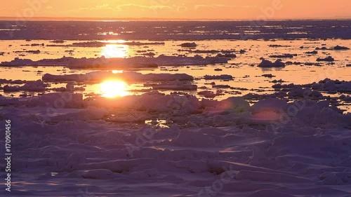 流氷のオホーツク海に沈む夕日 photo