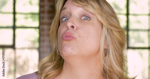 Woman puckering her lips for a kiss and winking
