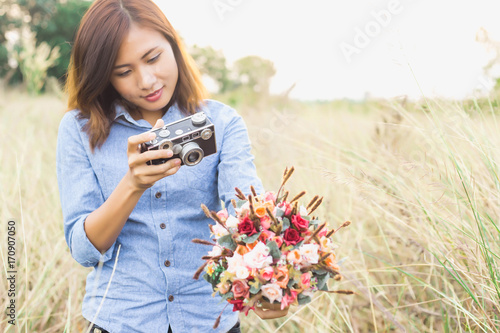 Woman photographed in a meadow with a camera. photo