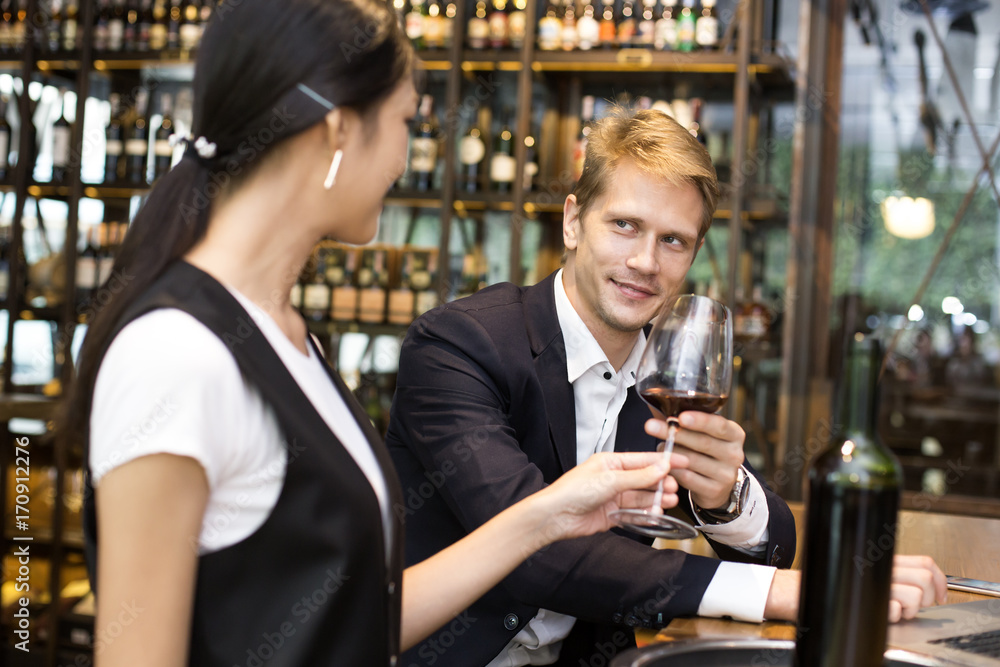 Businessman receive Wine from Waiter with Happy Emotion in restaurant, People Working at restaurant Concept. Businessman receive Wine from Waiter with Happy Emotion in restaurant, People Working at restaurant Concept.