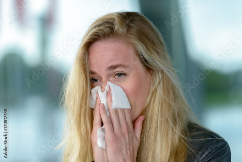 Tableau sur toile Young blond woman with hay fever