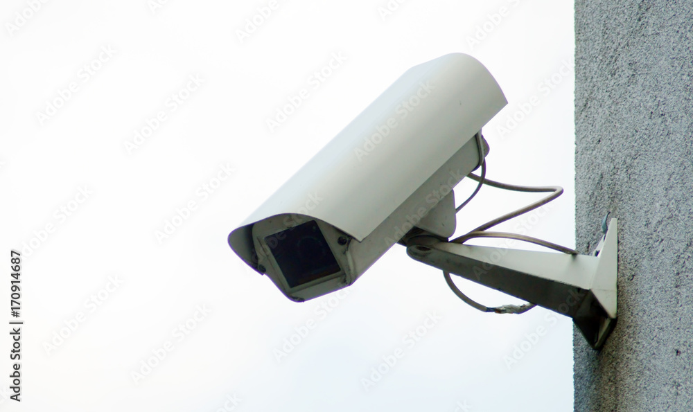 Camera surveillance on the wall of the building.