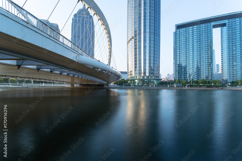 Obraz premium Tianjin Hai river waterfront downtown skyline with Dagu bridge,China.