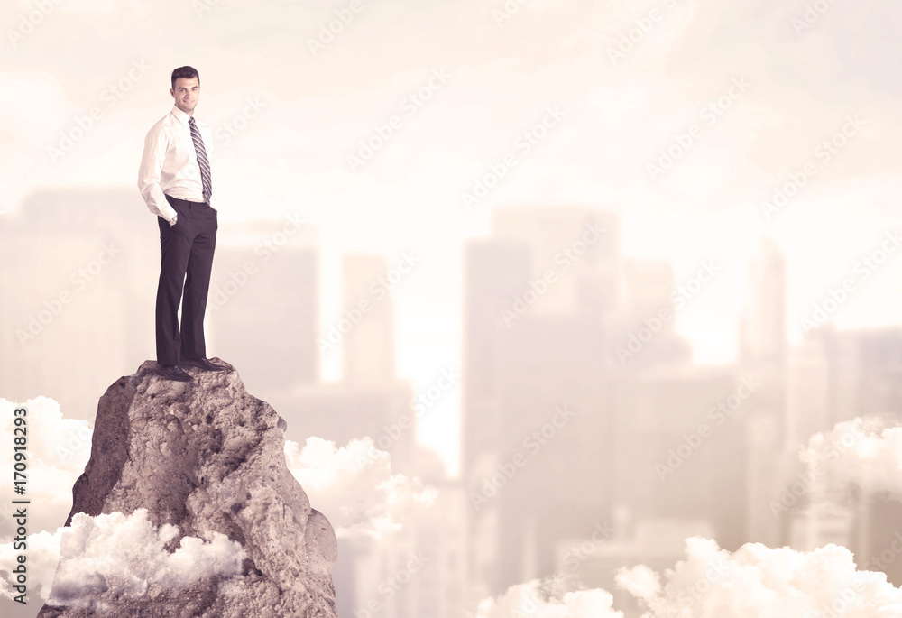 Confident businessman on dangerous cliff Confident businessman on dangerous cliff
