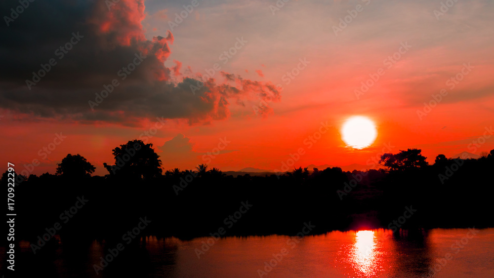 sunset beautiful in sky red color and silhouette tree with river reflect colorful landscape twilight time