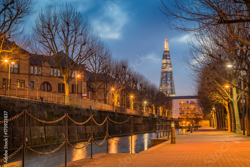 London, England - Ornamental canal at blue hour with beautiful skyscraper at background photo