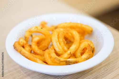 Hot french fries serve on white plate for food background or texture - Fast Food concept. © boyisteady