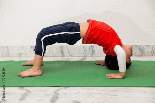A four year old  Indian kid doing yoga for fitness