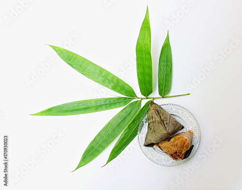 Zongzi and fresh bamboo leaf photo