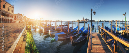 Gondolas in Venice - sunset with San Giorgio Maggiore church. San Marco, Venice, Italy