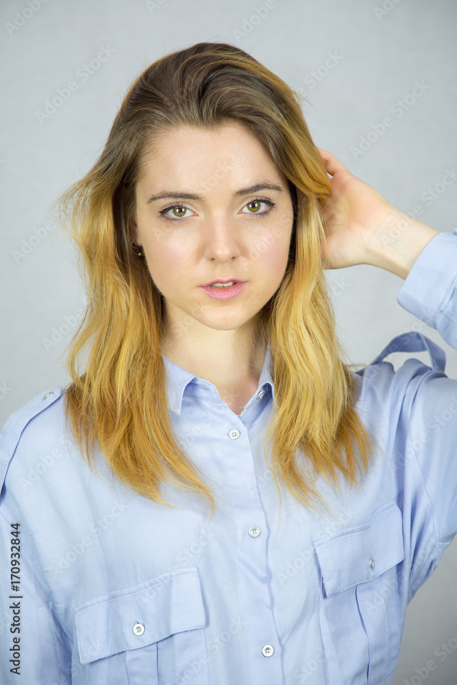 Pretty young woman model in casual clothes posing in studio. Pretty young woman model in casual clothes posing in studio.