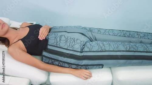 Woman relaxing during pressotherapy treatment procedure photo