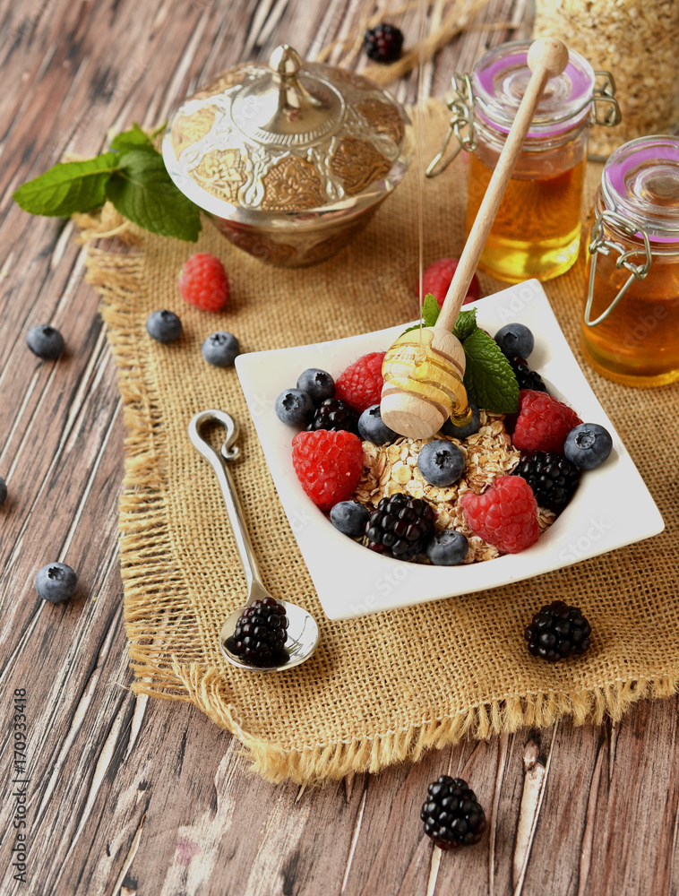 oatmeal with berries on a wooden table, selective focus oatmeal with berries on a wooden table, selective focus