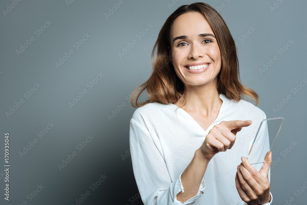 Joyful positive woman using her smartphone Joyful positive woman using her smartphone