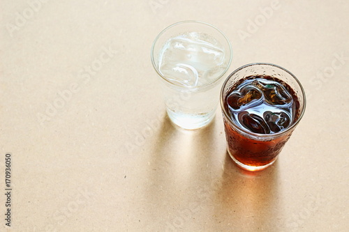 Drinking water and coca cola under natural light