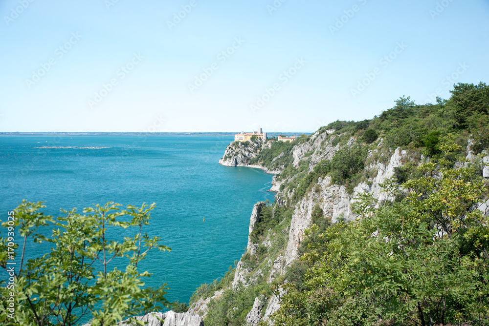 Duino Castle, a fortification of the 14th century in the Gulf of Trieste, seen from a panoramic footpath called Rilke trail. Northeastern Italy, Europe.