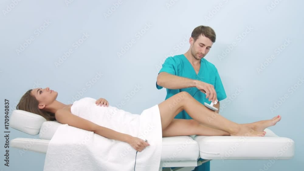 Young female patient on Electrostatic massage procedure Young female patient on Electrostatic massage procedure