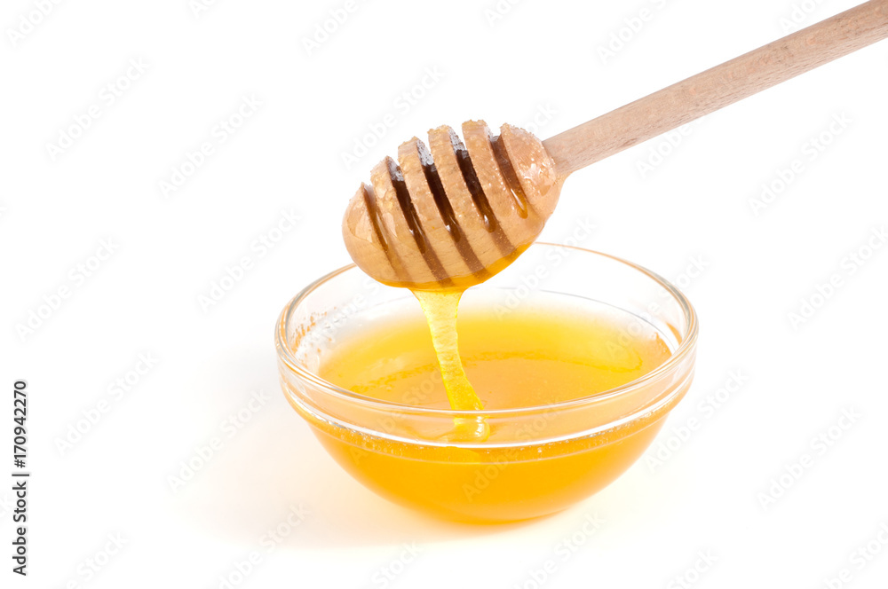Honey and dipper close-up on a white background Honey and dipper close-up on a white background
