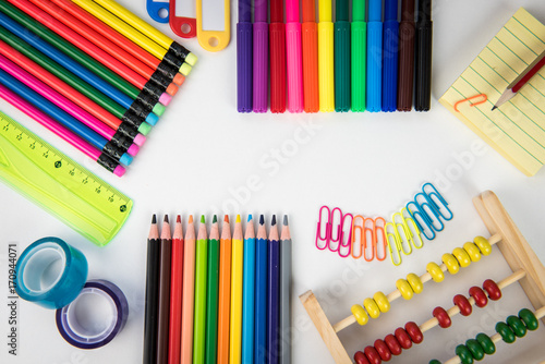 Rainbow of colors with school pencils school supplies and school accessories