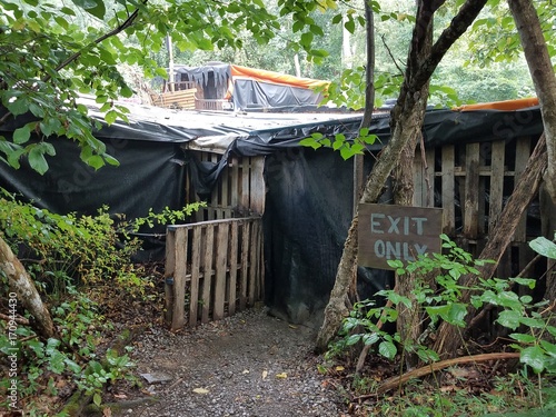 exit only sign and tarps over wood structure