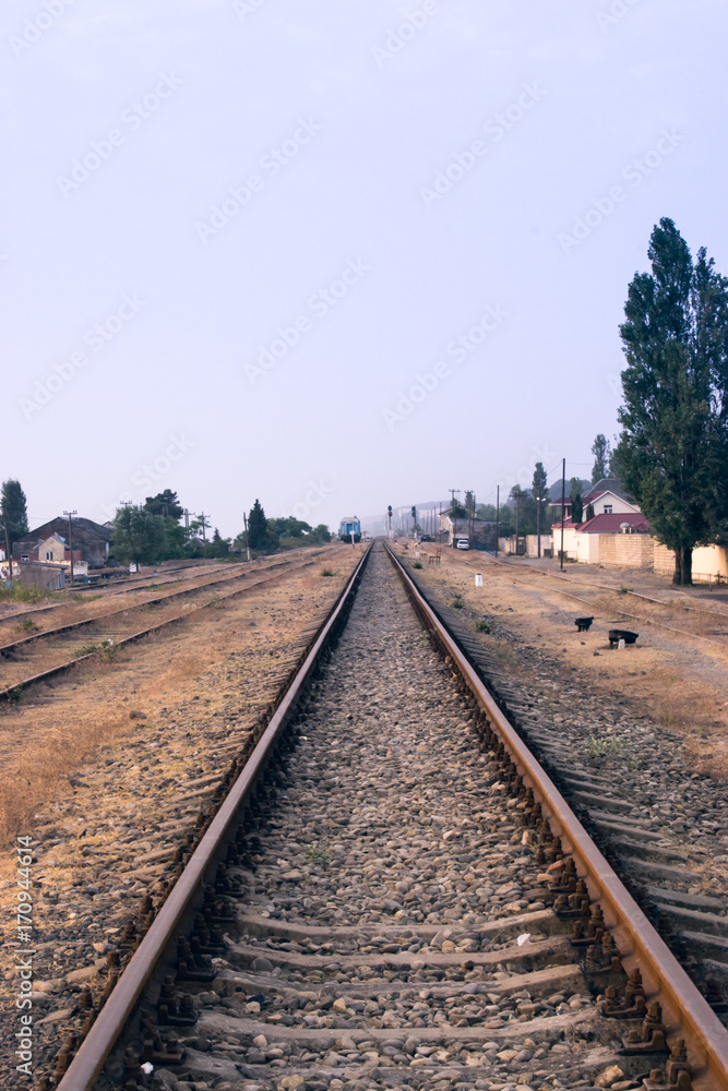 Obraz premium Railway station against beautiful sky at sunset.