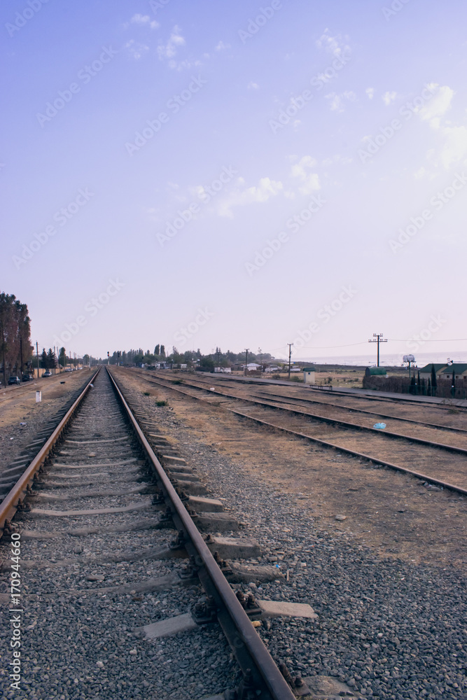 Naklejka premium Railway station against beautiful sky at sunset.