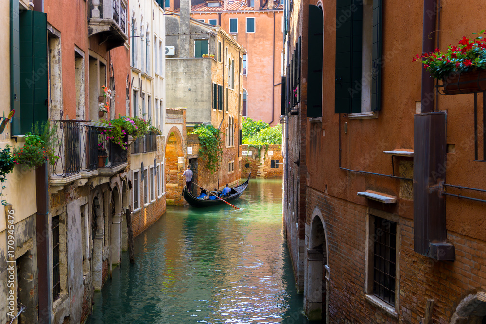 colorful Venetian Canal with gondola, Venice Italy