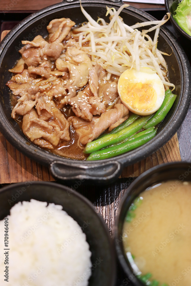 Pork rice with sauce in dish.