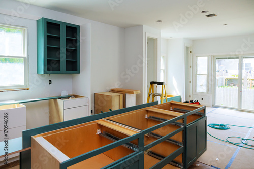 Fotografie Custom kitchen cabinets in various stages of installation base for island in cen