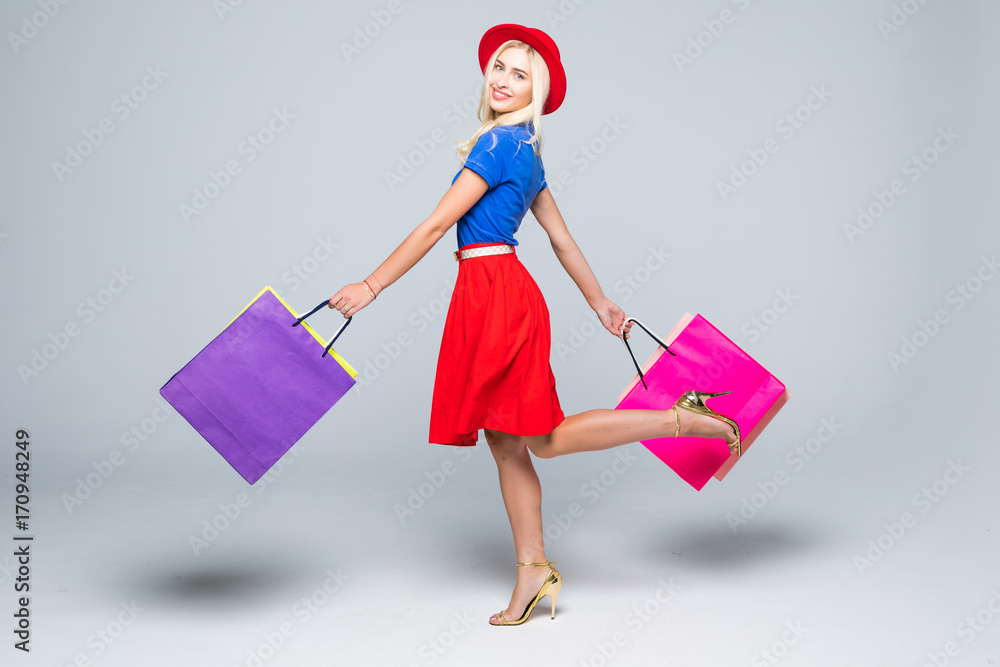Beautiful young women walking with bags, shopping concept, isolated on white background