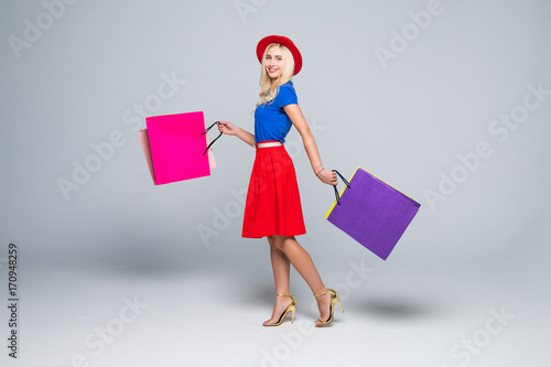 Beautiful young women walking with bags, shopping concept, isolated on white background