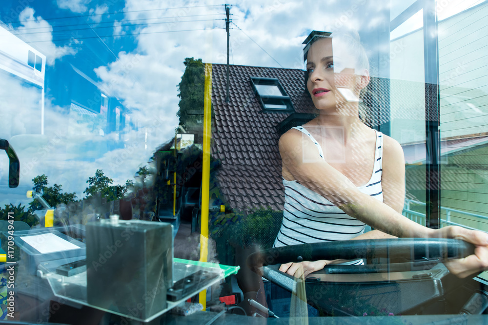 Fotografie Young woman in her function as a bus driver