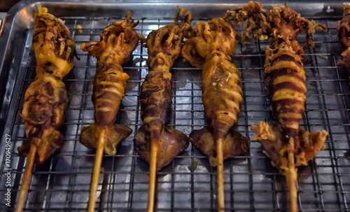 Asian street food, squid BBQ on stick photo