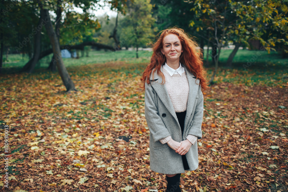 redhead girl in autumn park redhead girl in autumn park