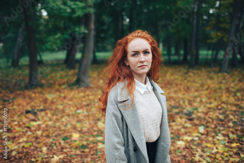 redhead girl in autumn park