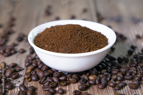 bowl with ground coffee and coffee beans 