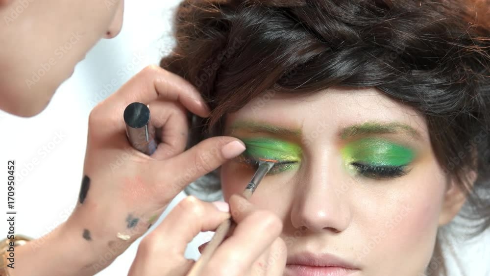 Visagist applying mascara. Model having makeup done. Visagist applying mascara. Model having makeup done.