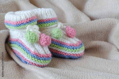 Newborn acessories, small shoes on soft background