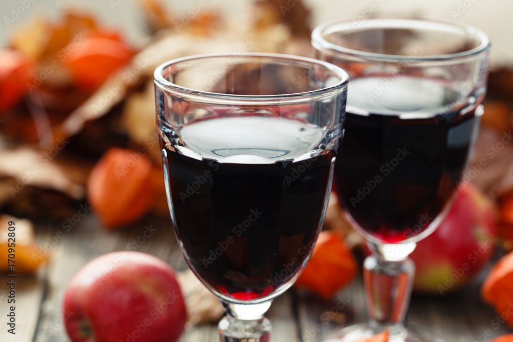 Red wine in glasses on table in fall leaf Red wine in glasses on table in fall leaf