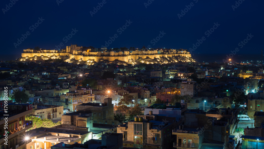 Glowing cityscape at Jodhpur at dusk. The majestic fort perched on top dominating the blue town. Scenic travel destination and famous tourist attraction in Rajasthan, India.