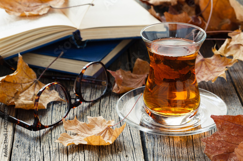 One glass cup of tea in autumn environment
