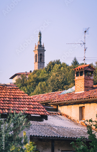 View of old bell tower over ancient italian rural houses