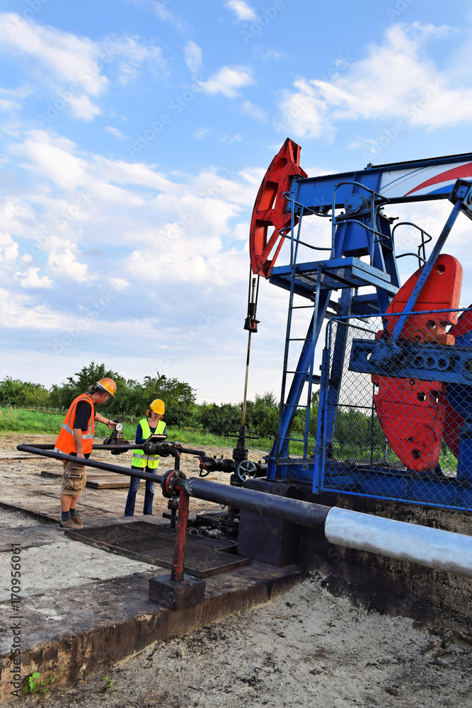 Two engineers at work on an European oil well Two engineers at work on an European oil well
