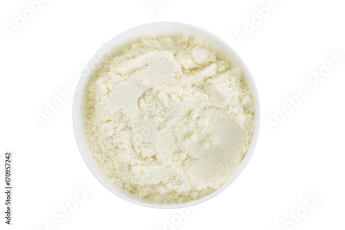 Closeup of powder milk in a white bowl. Top view.