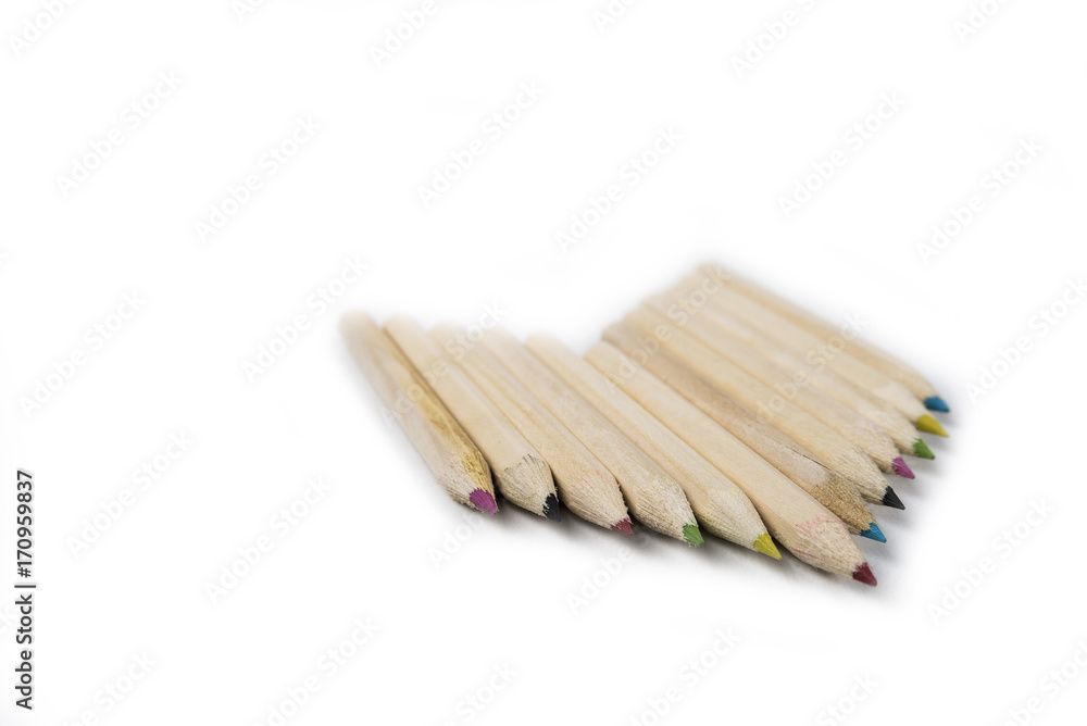 Back to school and classroom supplies with closeup on mix colored pencils on white background Back to school and classroom supplies with closeup on mix colored pencils on white background