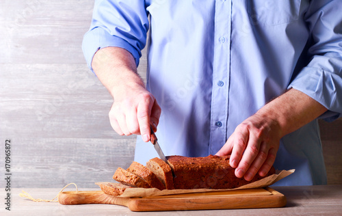 Man slicing freshly baked bread