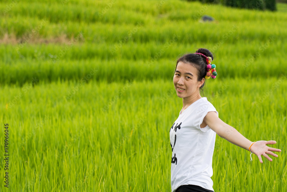Asian woman relaxing in rice terraces on holiday Asian woman relaxing in rice terraces on holiday