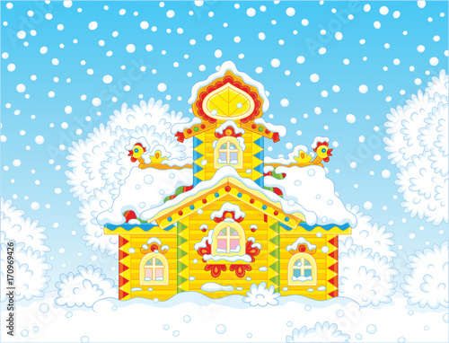 Colorfully decorated small wooden tower covered with snow on Christmas