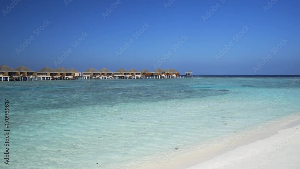 Private Bungalows against a Bold Horizon in the Maldives Private Bungalows against a Bold Horizon in the Maldives